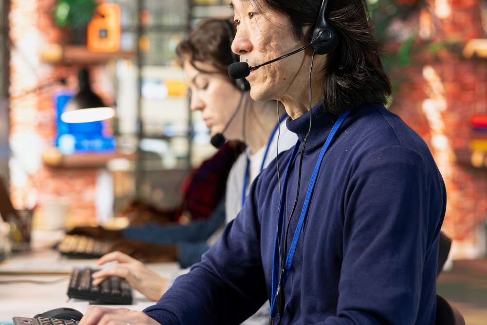 Focused virtual assistants wearing headsets and working on computers — delivering logistics virtual assistant services for real-time shipment support and dispatch coordination.