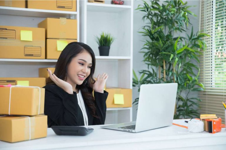 Happy logistics coordinator managing packages online — understanding what is linear feet for eCommerce shipping efficiency.